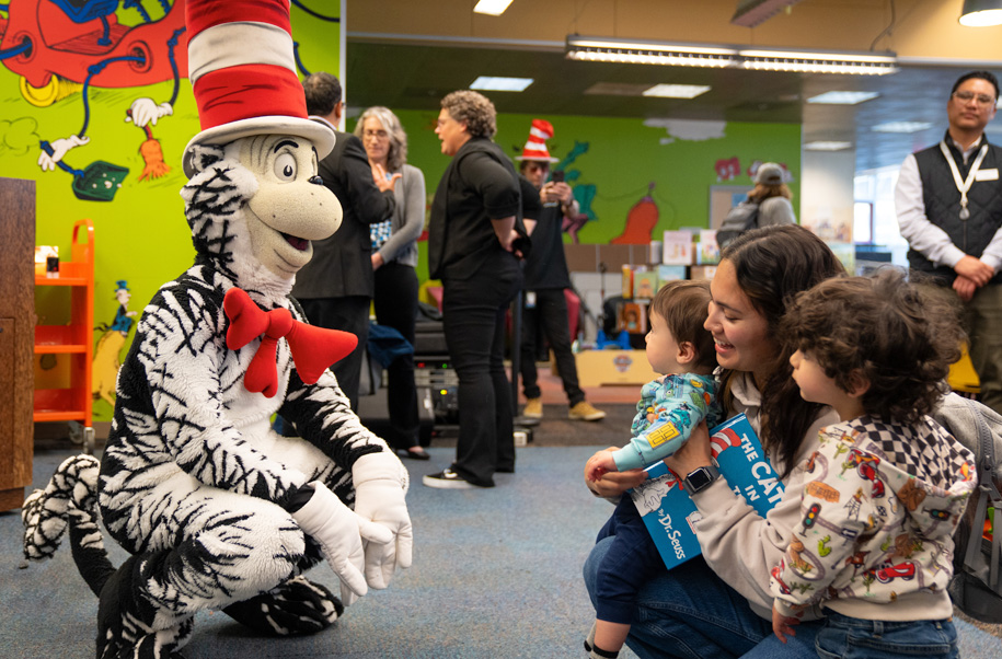 A performer dressed as the Cat in the Hat entertains children